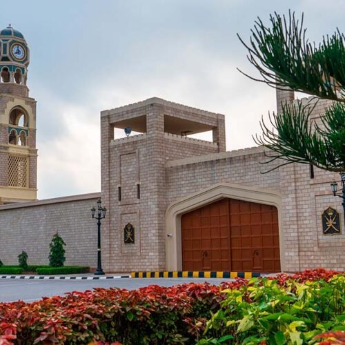 Al Hosn Palace in Salalah behind palm trees