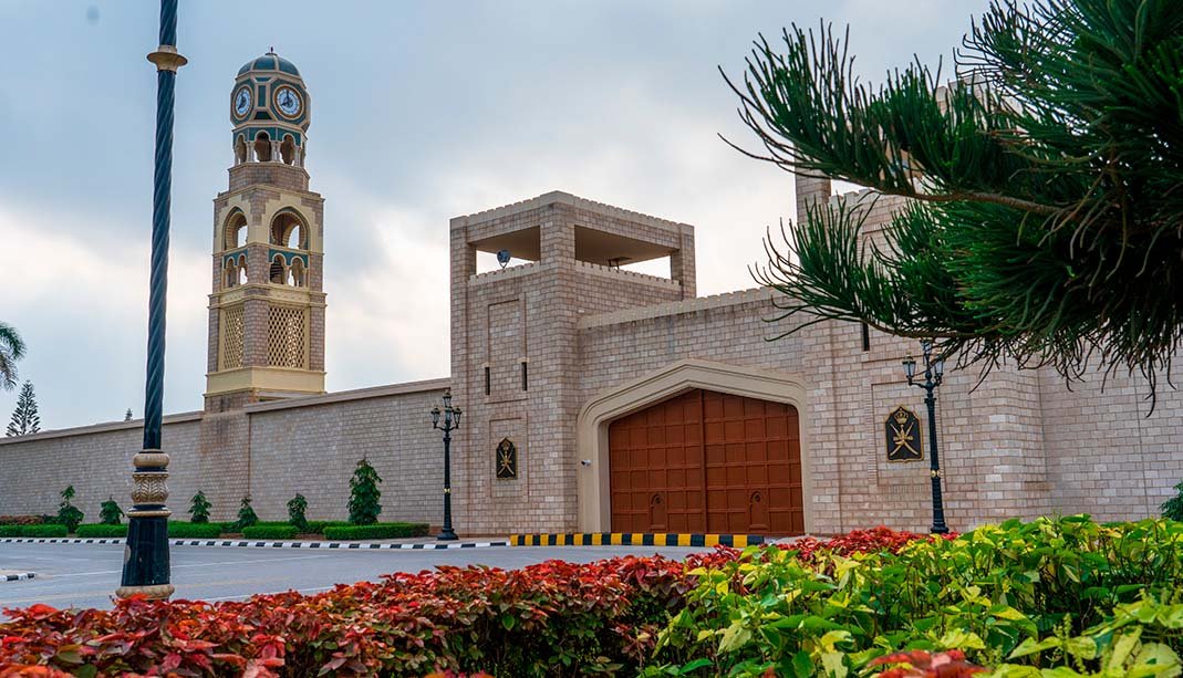 Al Hosn Palace in Salalah behind palm trees