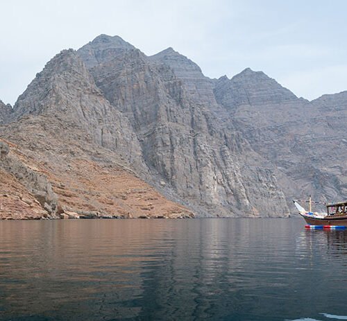 A dhow on a hazy day in the fjords of Musandam