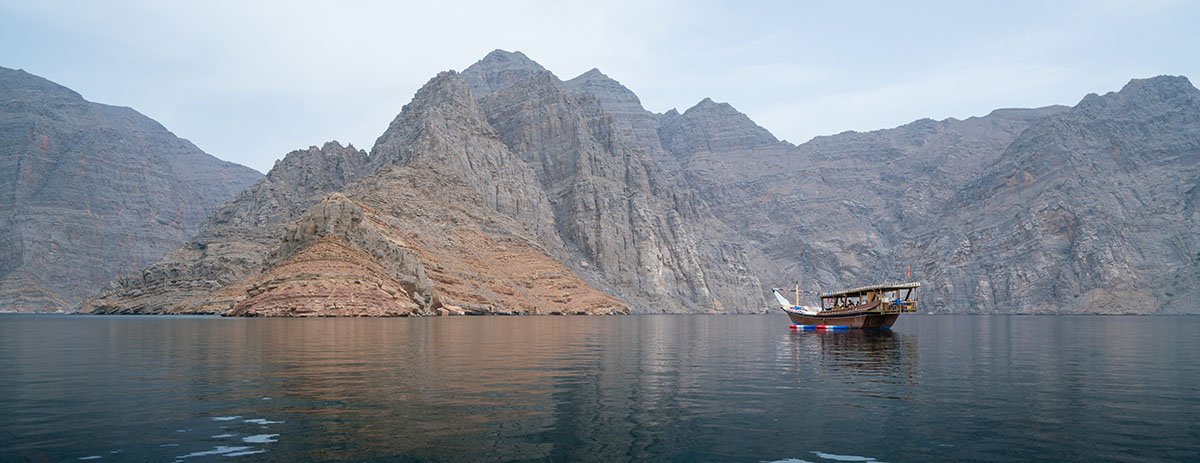 A dhow on a hazy day in the fjords of Musandam
