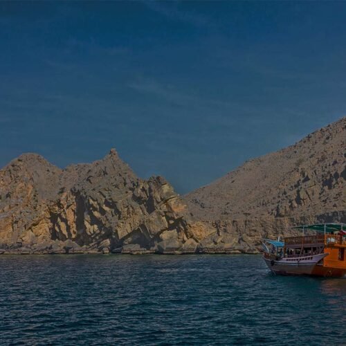 A dhow in a Musandam fjord in the evening light