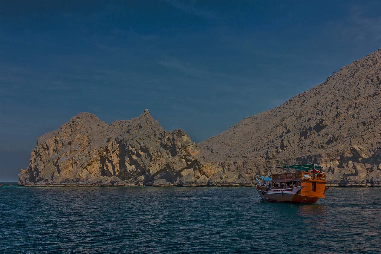 A dhow in a Musandam fjord in the evening light