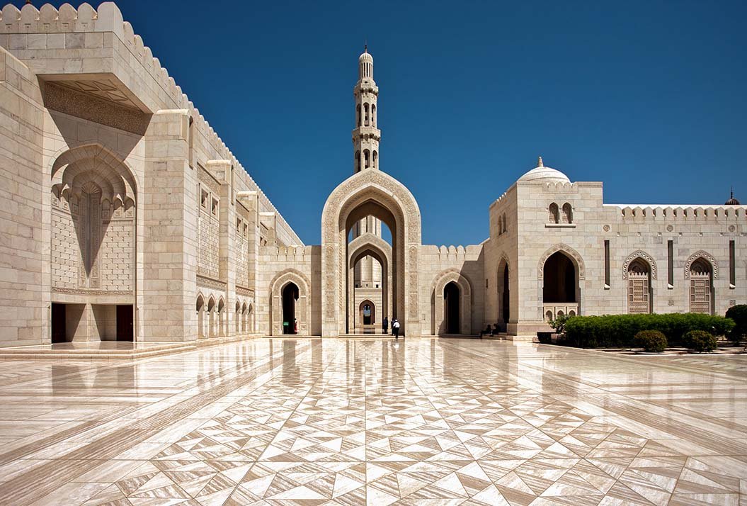 Marble arcades and the minaret of the Sultan Qaboos Grand Mosque