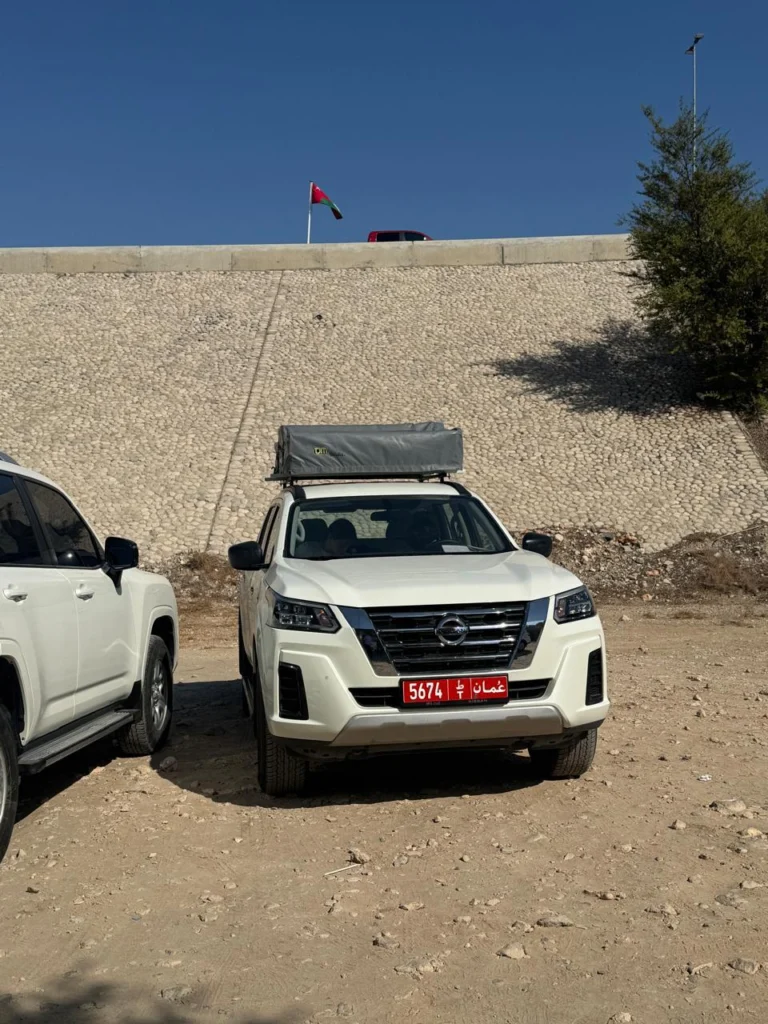 A white fleet 4x4 parked and ready to go, with another beside it
