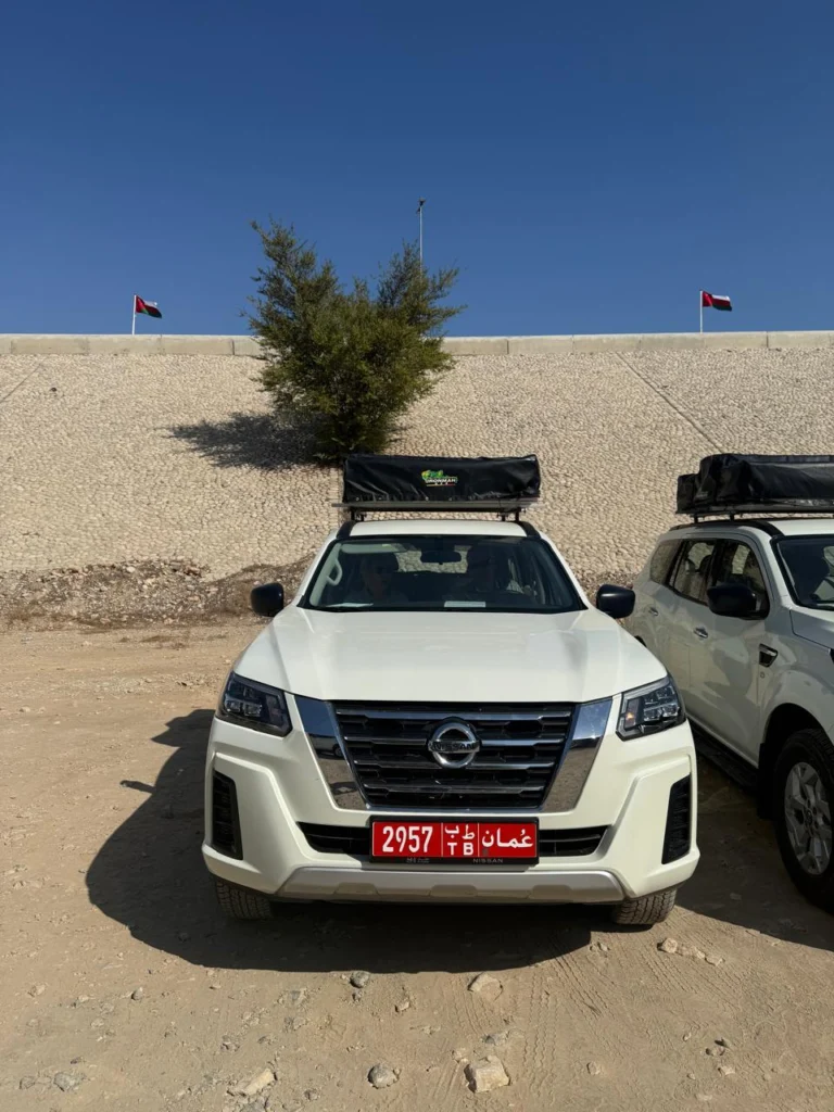 The front of a white fleet 4x4 with a roof rack, parked ready for handover