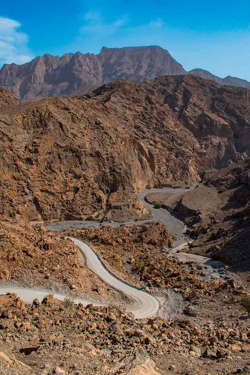 A road winding through a rocky canyon towards Jebel Harim