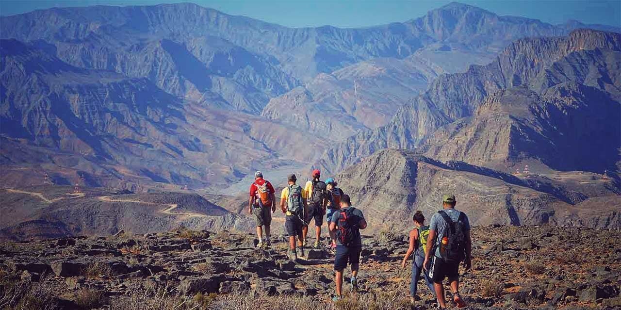 Hikers on a mountain path in Musandam