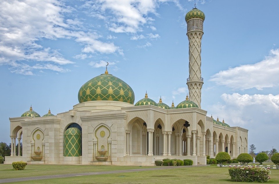 Mosque with green domes and a tall minaret