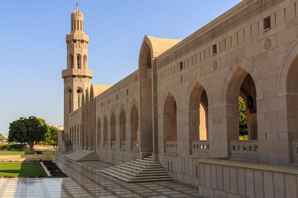 Arched walkway and minaret at the Sultan Qaboos Grand Mosque