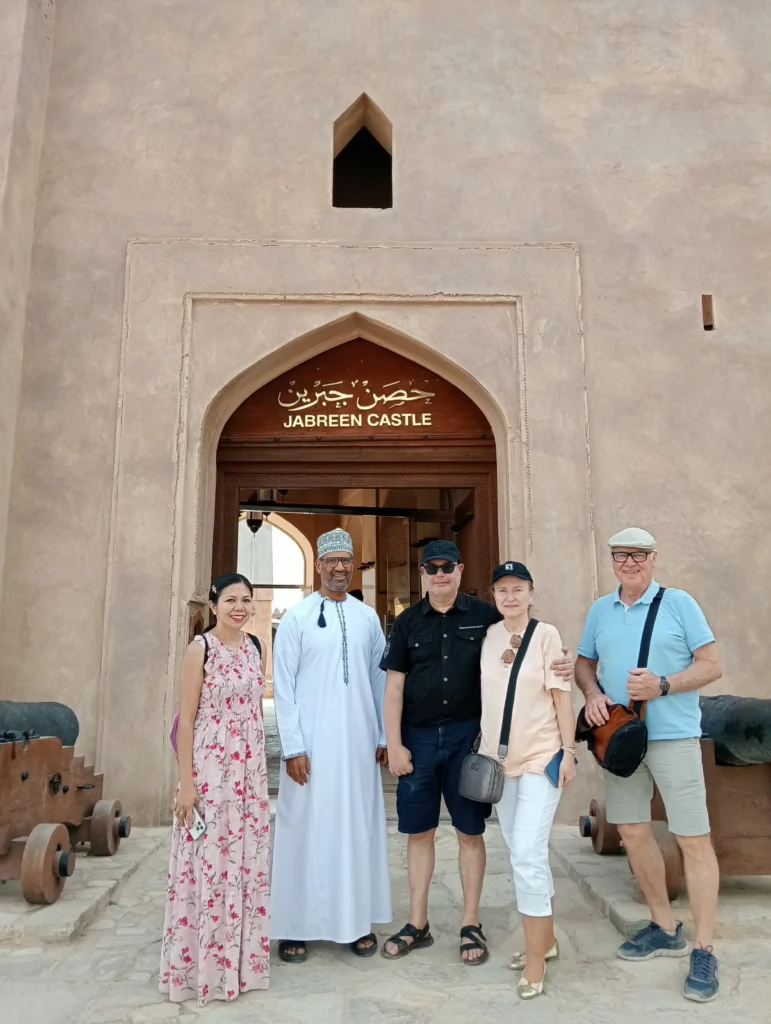 Guests and their guide at the entrance of Jabreen Castle